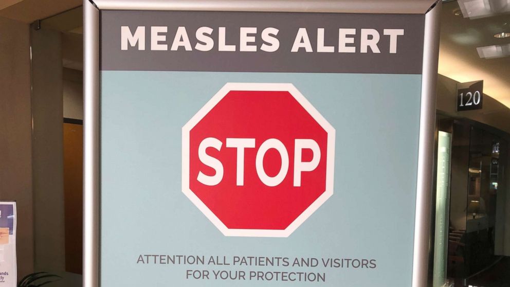 Signs are posted at The Vancouver Clinic in Vancouver, Wash., to warn patients and visitors of a measles outbreak, Jan. 30, 2019.