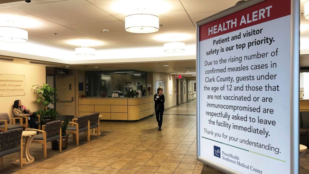 PHOTO: A sign prohibiting all children under 12 and unvaccinated adults stands at the entrance to PeaceHealth Southwest Medical Center in Vancouver, Wash., Jan. 25, 2019. 