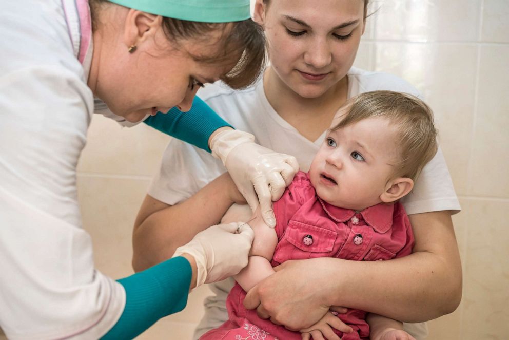 PHOTO: Sonya Yanchuk, age 1, gets her measles vaccine shot in a health clinic in Kiev, Ukraine, May 15, 2019.