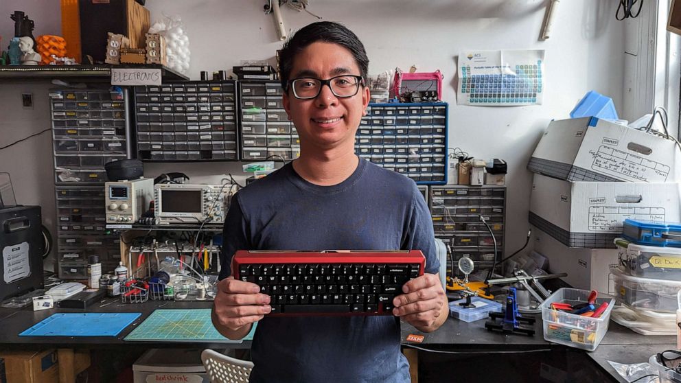 PHOTO: John Poblador shows off his custom mechanical keyboard.