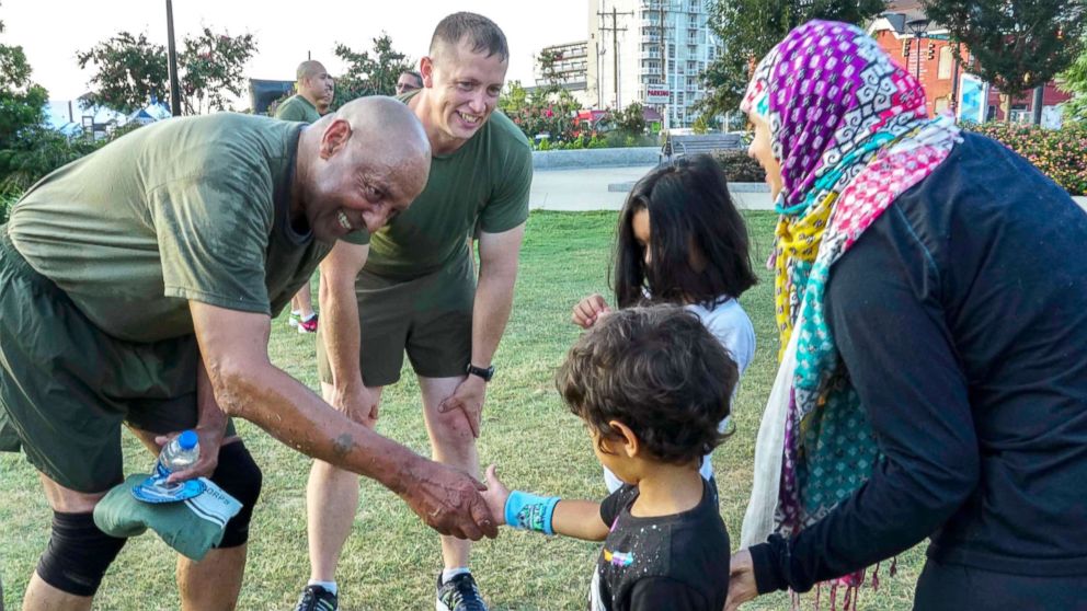 PHOTO: Retired U.S. Marine Corps, retired, Sgt. Maj. John Canley, left, and a local citizen pose for a photo after a physical training session during Marine Week in Charlotte, N.C., Sept. 7 2018. 