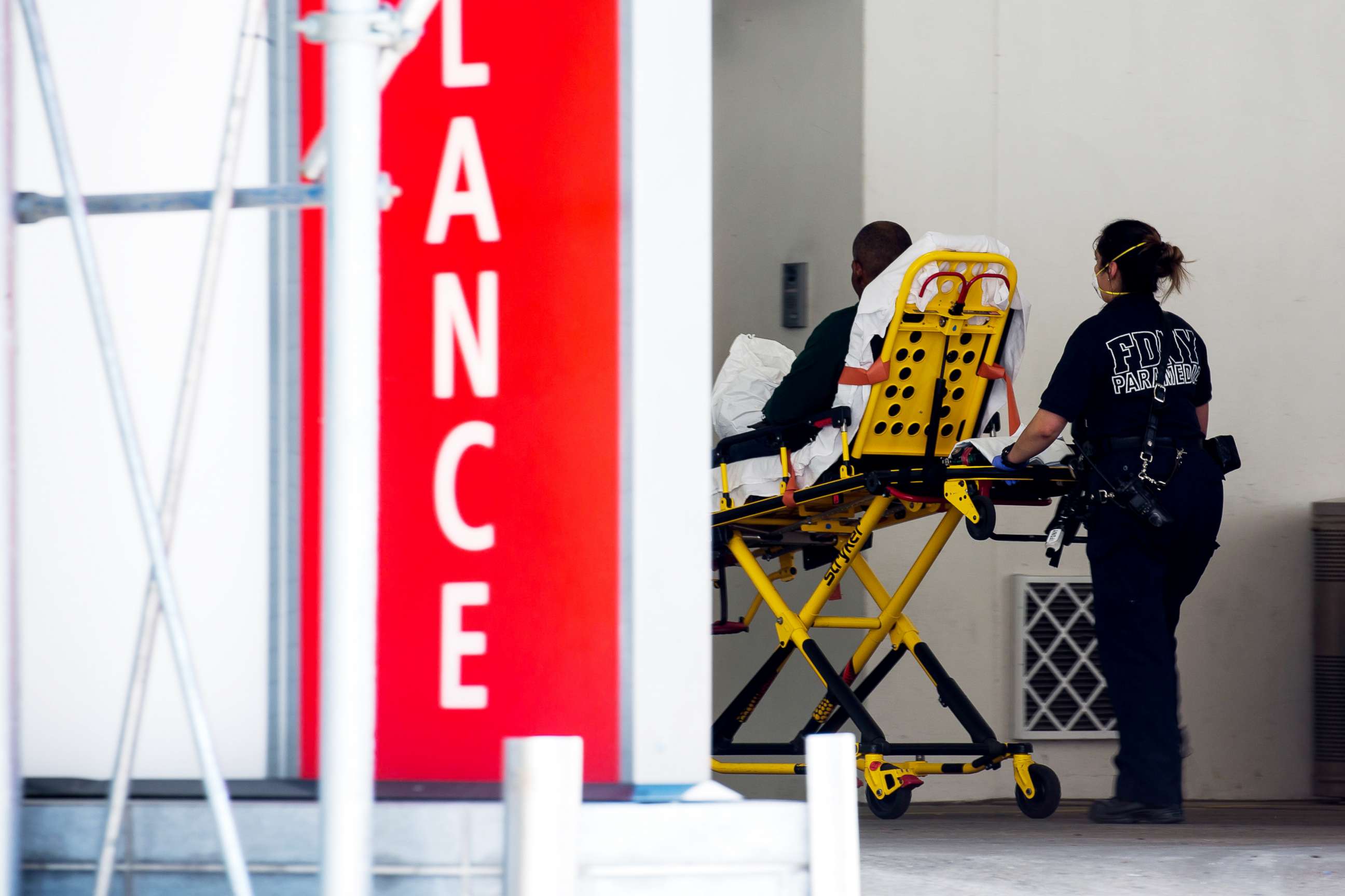 PHOTO: A healthcare worker wheels a stretcher into the emergency room at Lenox Health Greenwich Village in New York, May 26, 2020.