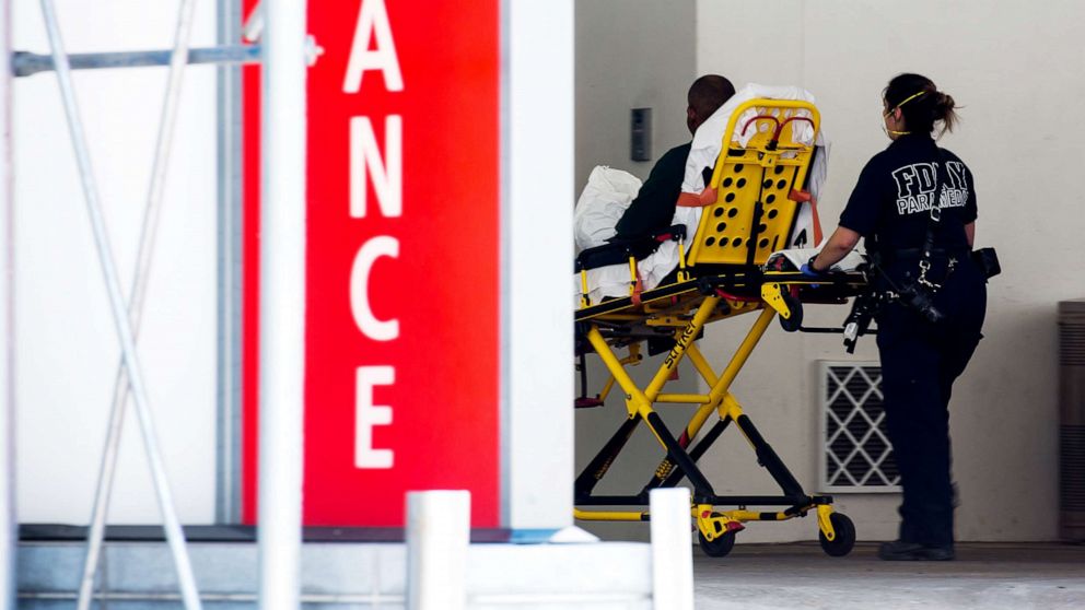 PHOTO: A healthcare worker wheels a stretcher into the emergency room at Lenox Health Greenwich Village in New York, May 26, 2020.