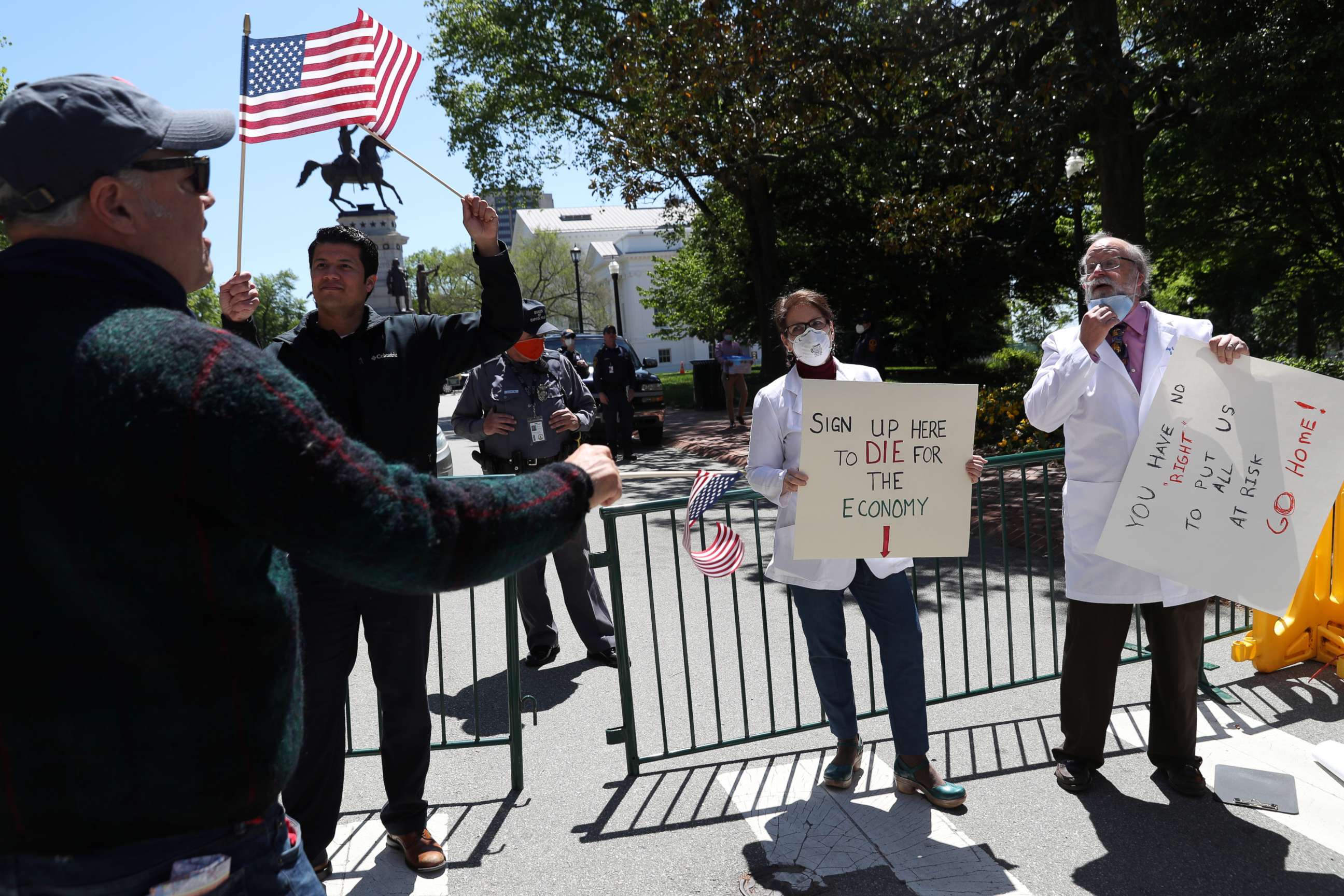 PHOTO: A demonstrator protesting against lockdown to limit the spread of coronavirus argues with counter-demonstrators Dr. Erich Bruhn and former nurse Kristin Bruhn, during a rally calling for the reopening of the state in Richmond, Va., April 22, 2020.