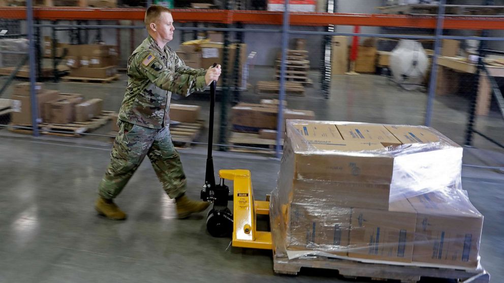 PHOTO: A Indiana National Guardsman pushes a pallet of medical supplies to be delivered, March 26, 2020, in Indianapolis. 