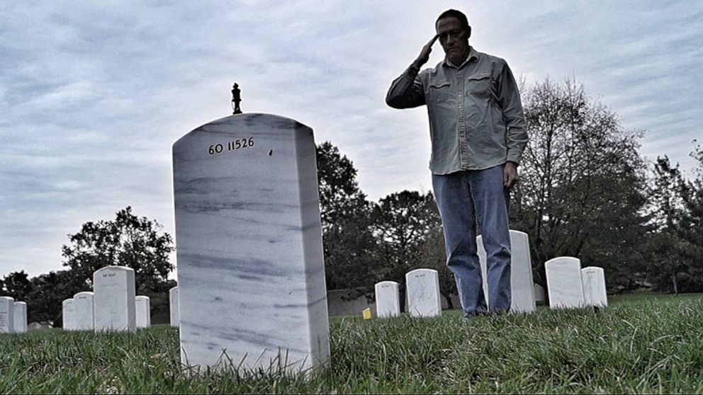 PHOTO: After placing a chess piece on his headstone, Henry Black salutes his son, Army Staff Sgt. Bryan Black, who was killed in Tongo Tongo, Niger, in 2017.