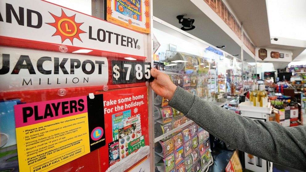 PHOTO: A clerk at Broad Street Liquors updates the Mega Millions jackpot at the store's lottery counter, Tuesday, Jan. 3, 2023, in Timonium, Md.