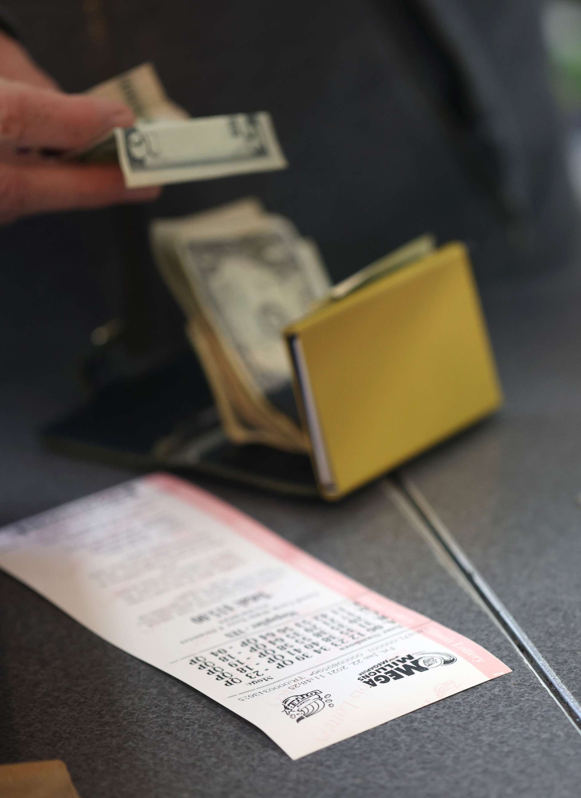 PHOTO: A customer purchases a Mega Millions lottery ticket in Chicago, Jan. 22, 2021.