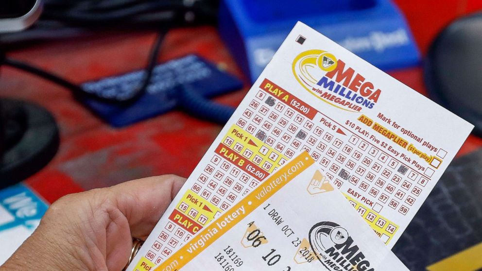 PHOTO: In this Oct. 22, 2018, file photo, a customer purchases Mega Millions lottery tickets at a retailer in Arlington, Virginia.