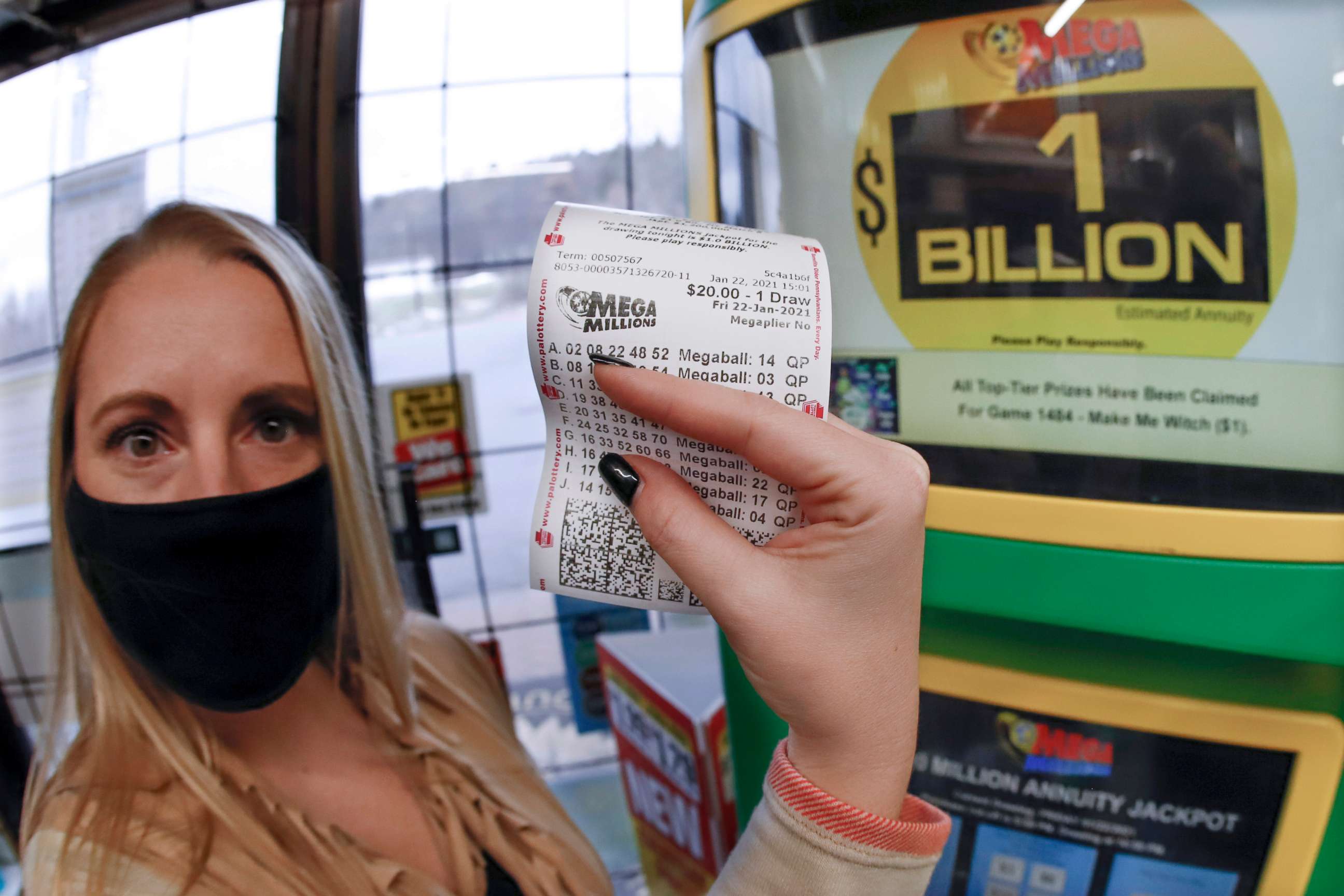 PHOTO: A patron, who did not want to give her name, shows the ticket she had just purchased for the Mega Millions lottery drawing at the lottery ticket vending kiosk in a Smoker Friendly store, Friday, Jan. 22, 2021, in Cranberry Township, Pa.