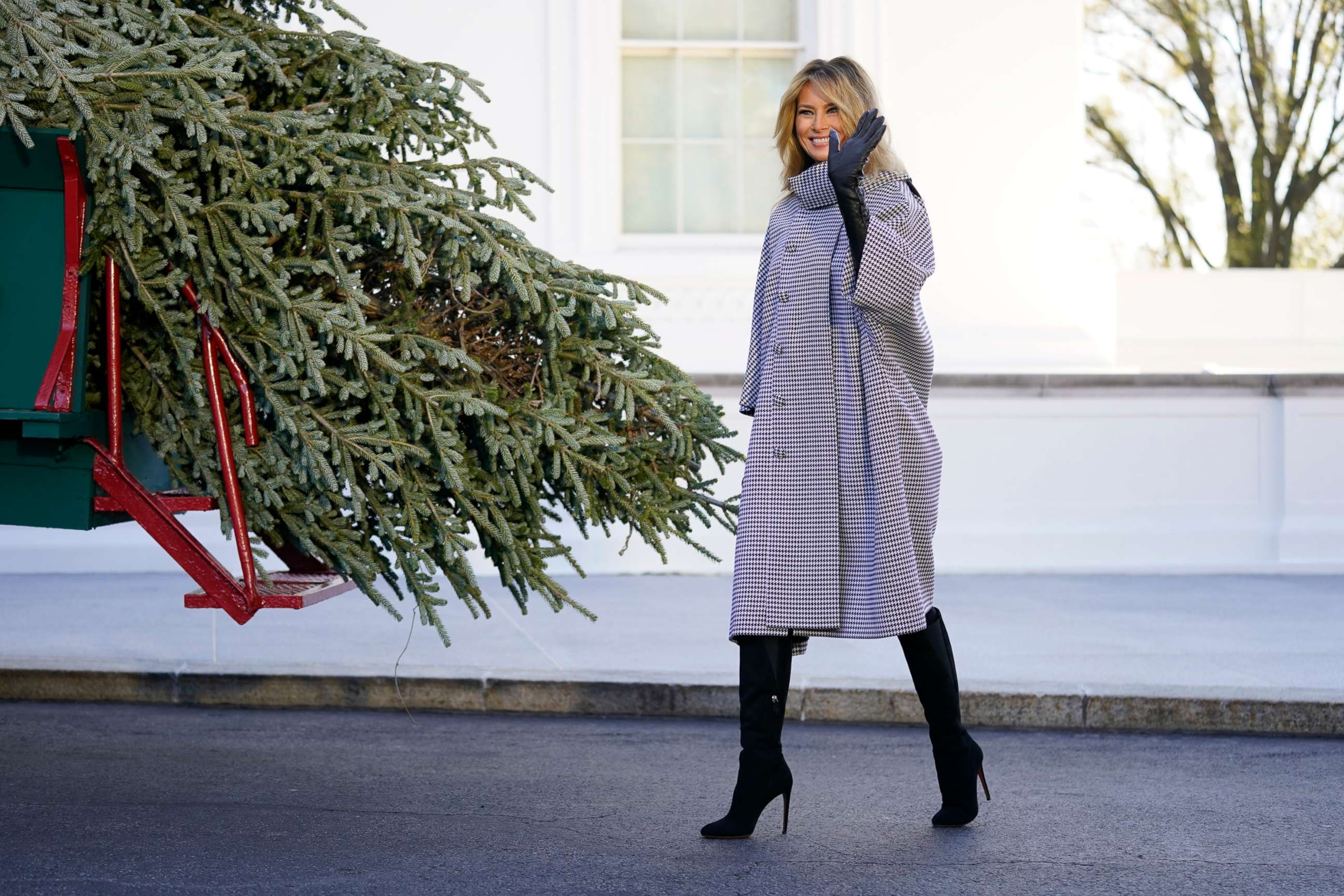 PHOTO: First lady Melania Trump waves as she stands next to the 2020 Official White House Christmas tree as it is presented on the North Portico of the White House, Nov. 23, 2020, in Washington.