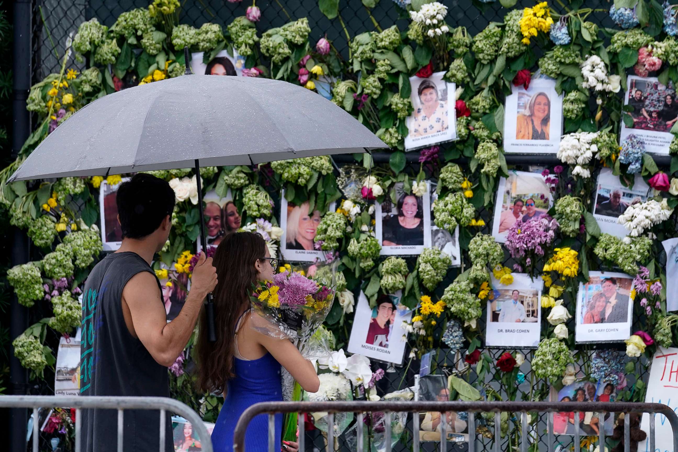 PHOTO: Visitors bring flowers to add to a makeshift memorial for the scores of people who were left missing after the Champlain Towers South condo building partially collapsed nearly a week ago, June 30, 2021, in Surfside, Fla., near Miami Beach.