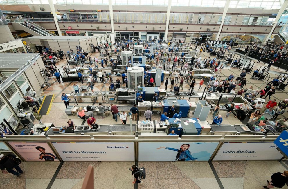 PHOTO: Travelers queue up at the south security checkpoint in the main terminal of Denver International Airport, May 26, 2022, in Denver.