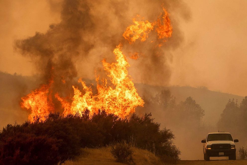 PHOTO: Flames leap above a vehicle on High Valley Rd as the Ranch Fire, part of the Mendocino Complex Fire, burns near Clearlake Oaks, Calif., Aug. 5, 2018.