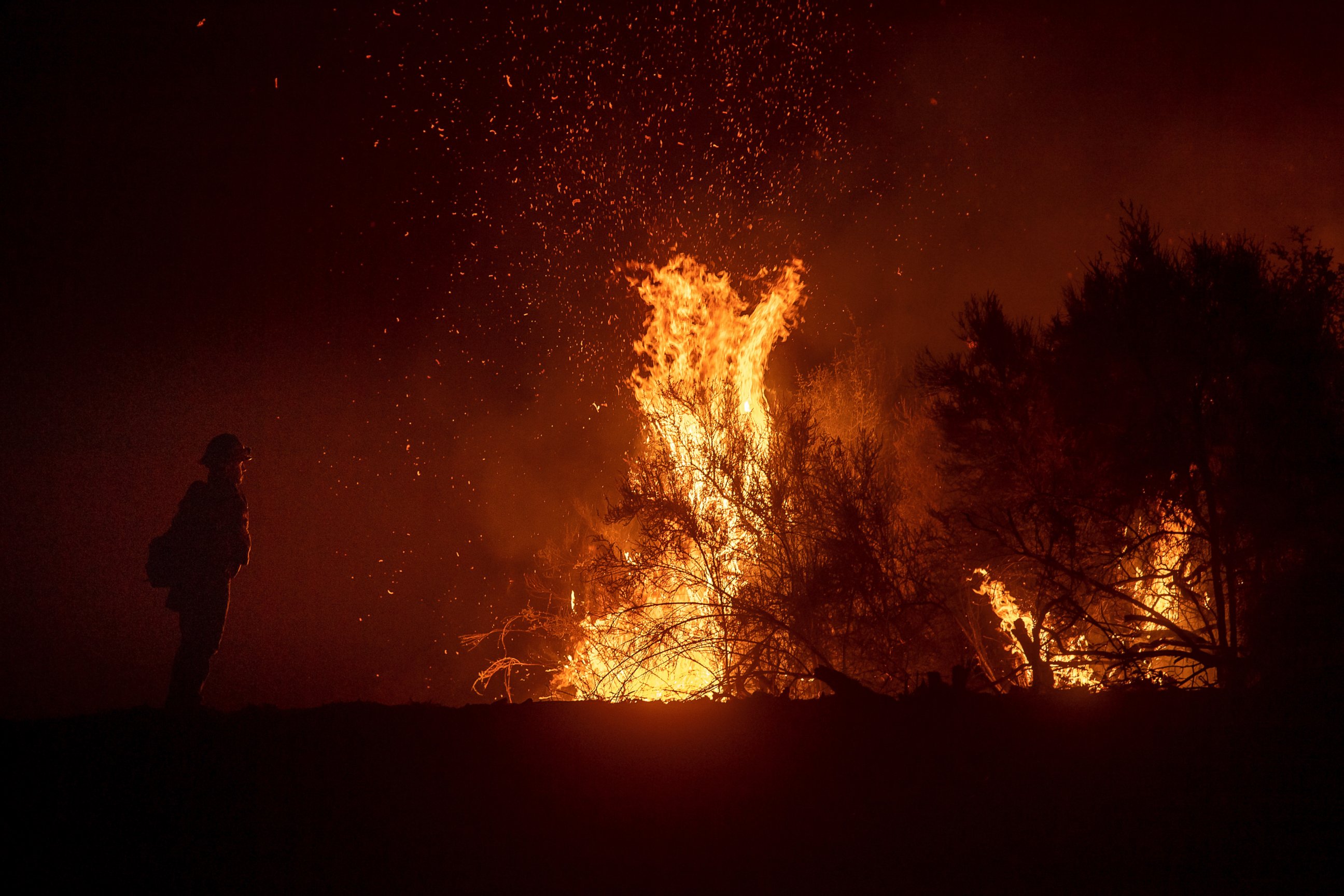 A firefighter monitors a backfire while battling the Ranch Fire, part of the Mendocino Complex Fire, on Tuesday, Aug. 7, 2018, near Ladoga, Calif.