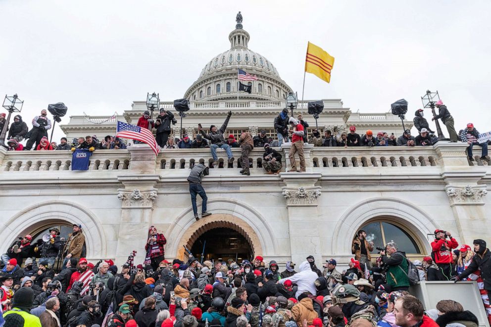 PHOTO: Protesters scale the walls of Capitol building where pro-Trump supporters riot and breached the Capitol during the certification of the results of the 2020 Presidential election, Jan. 6, 2021.