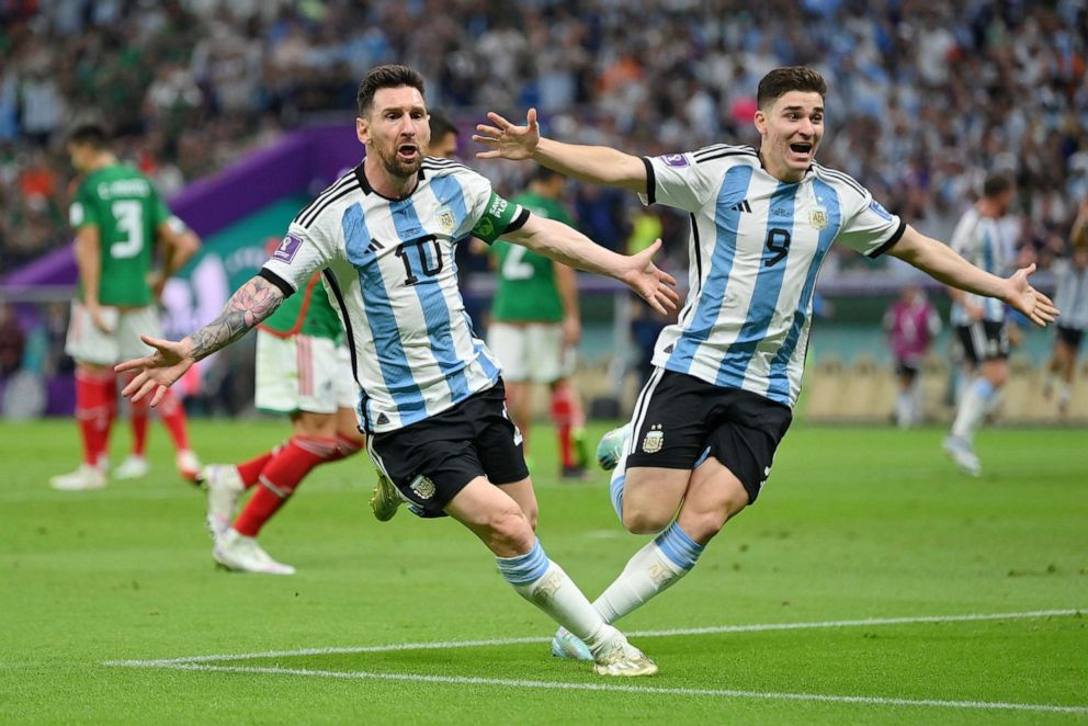 PHOTO: Lionel Messi (L) of Argentina celebrates scoring their team's first goal with their teammate Julian Alvarez (R) during the FIFA World Cup match between Argentina and Mexico at Lusail Stadium on Nov. 26, 2022, in Lusail, Qatar.