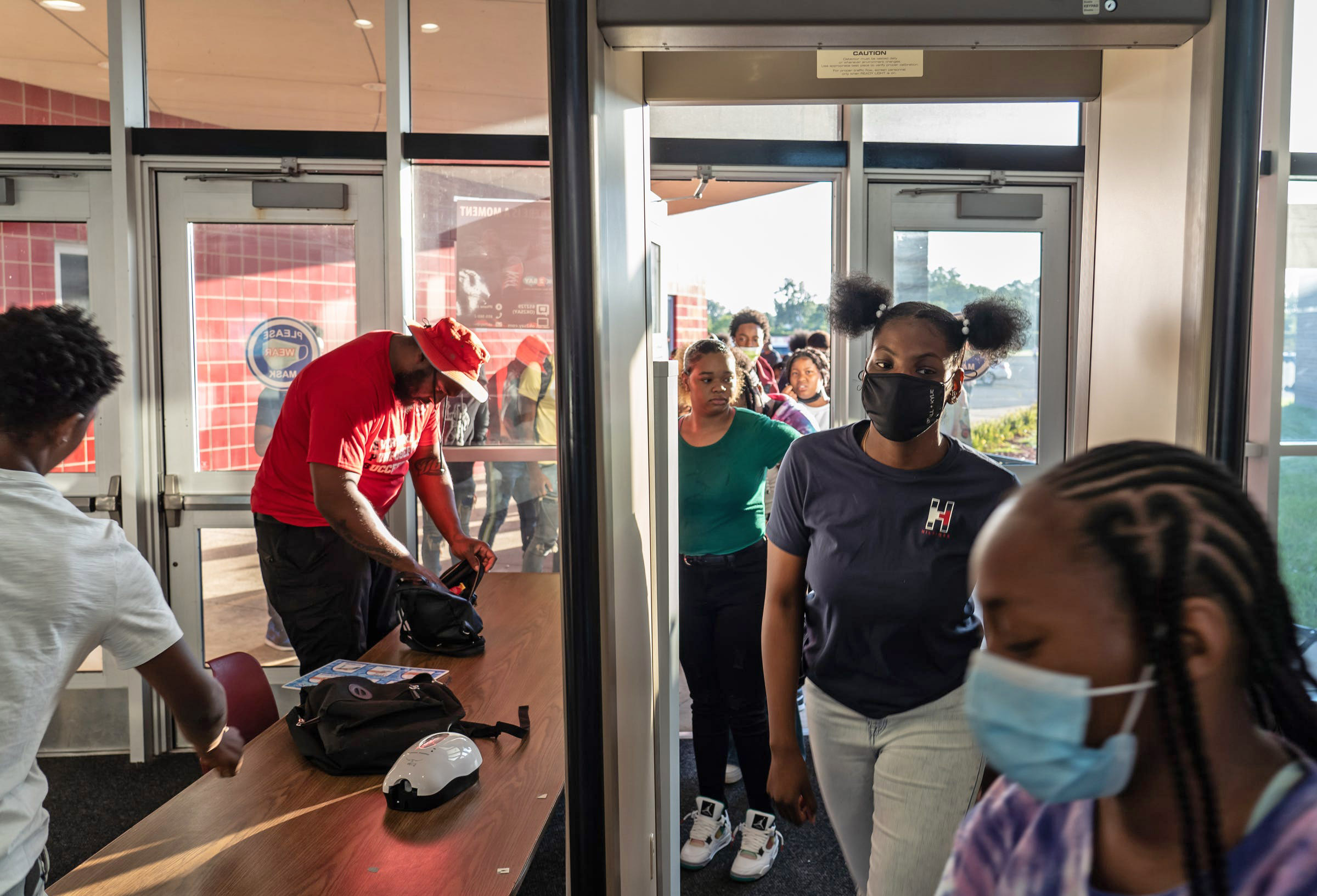 PHOTO: Ecorse High School students go through security search and pass through a metal detector during the first day of school at Ecorse High School in Ecorse on Tuesday, September 7, 2021.