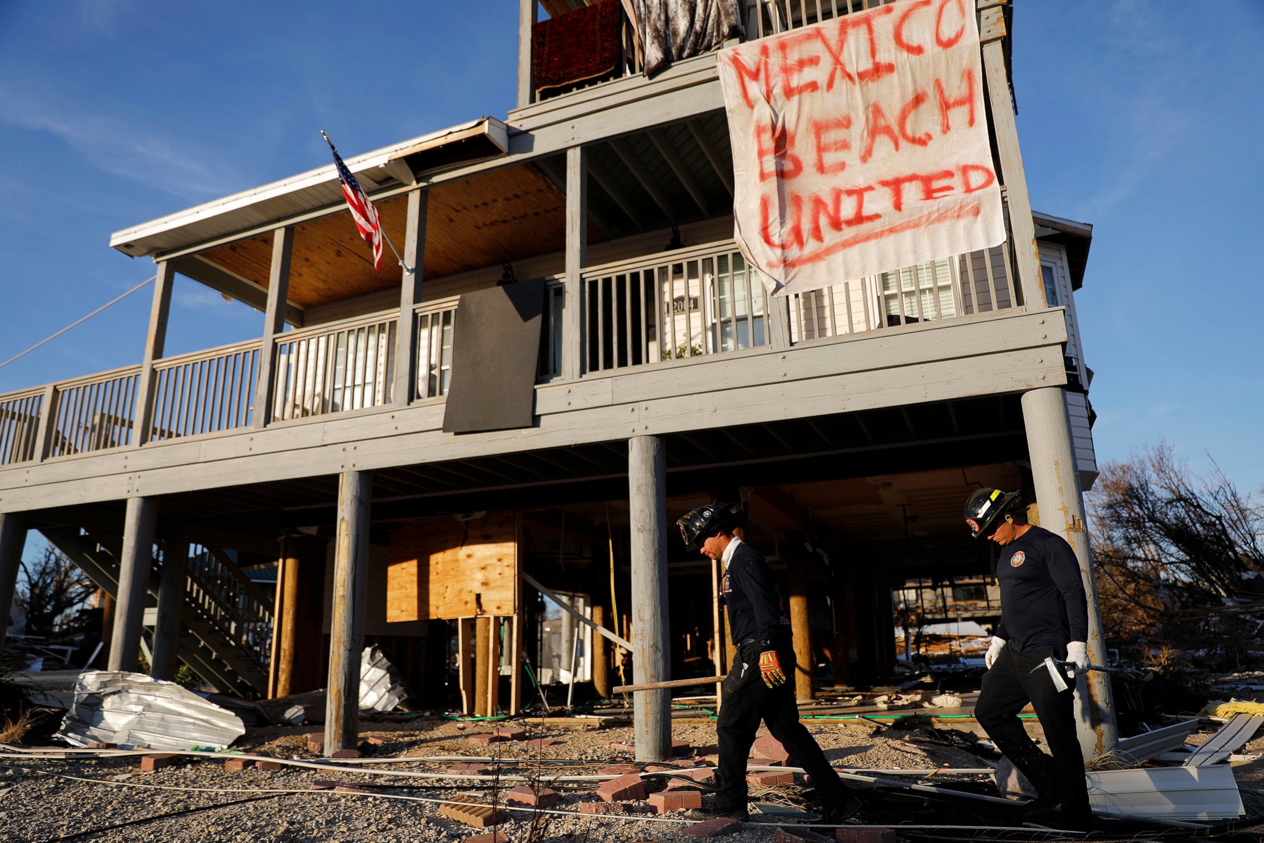 PHOTO: A banner hangs from a damaged home as a South Florida urban search and rescue team checks for survivors of hurricane Michael in Mexico Beach, Fla., Friday, Oct. 12, 2018.
