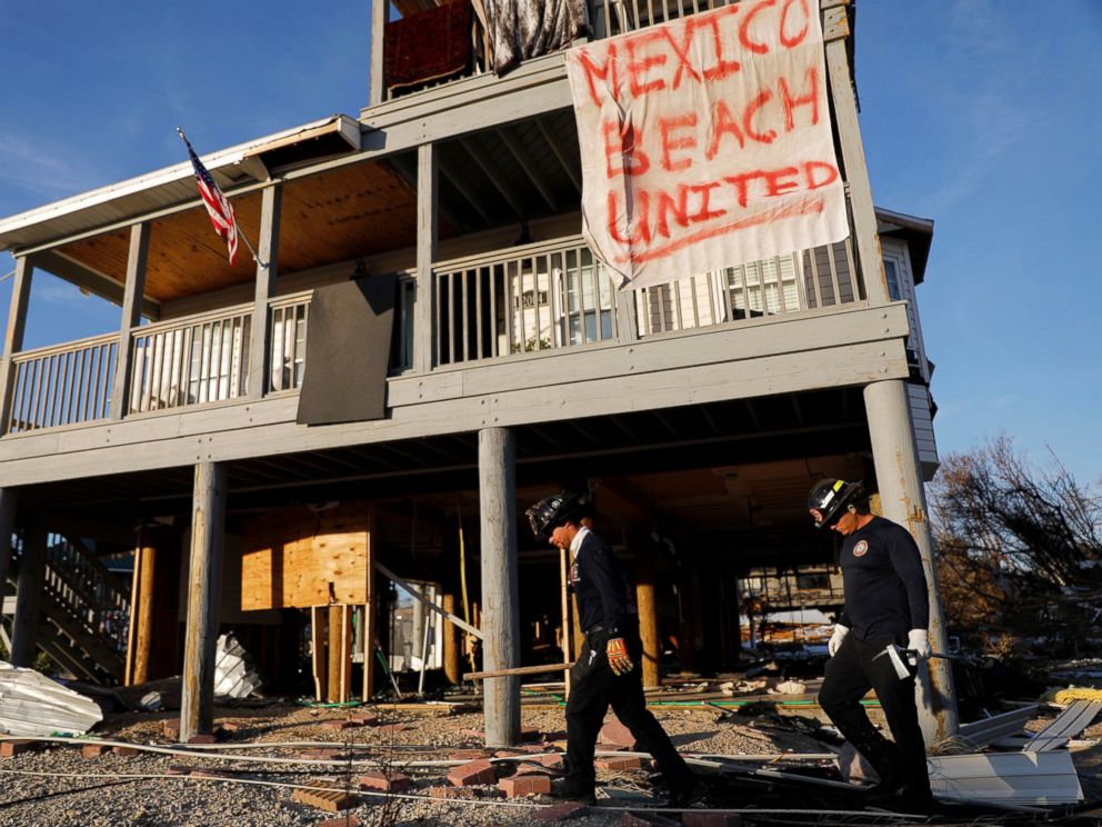 PHOTO: A banner is hanging on a damaged house while an urban search and rescue team in South Florida checks for the presence of Hurricane Michael survivors in Mexico Beach, Florida on Friday, October 12, 2018.