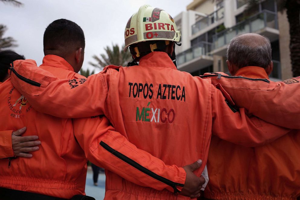 PHOTO: Members of Mexican Topos Azteca rescue team pose for a photo as they wait for access to the site of a partially collapsed residential building as search and rescue operations continue, in Surfside, near Miami Beach, Fla., June 30, 2021.