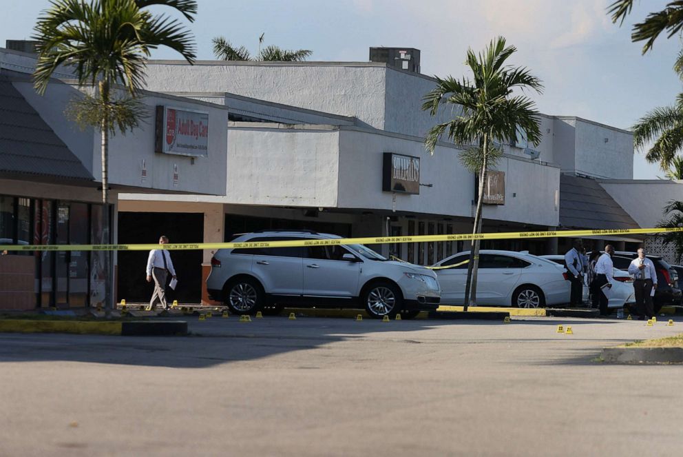 PHOTO: Miami-Dade police investigate near shell case evidence markers on the ground where a mass shooting took place outside of a banquet hall on May 30, 2021, in Hialeah, Fla.