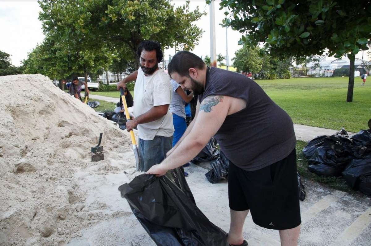 PHOTO: Miami resident Jan-Michael Medina collecting sandbags with his brother-in-law Charlie Hernandez.
