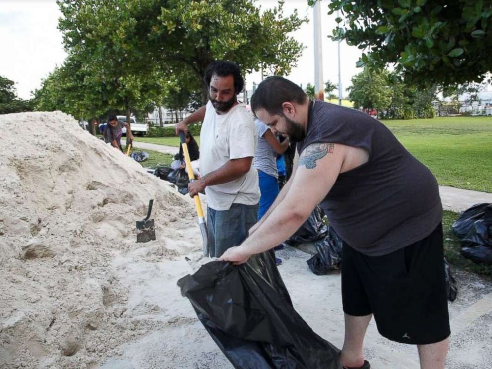 PHOTO: Miami resident Jan-Michael Medina collecting sandbags with his brother-in-law Charlie Hernandez.