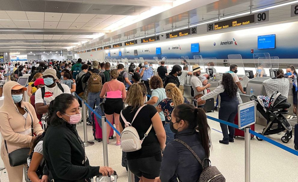 PHOTO: Travelers line up by the American Airline departure check in desks at Miami International Airport, Aug. 2, 2021.
