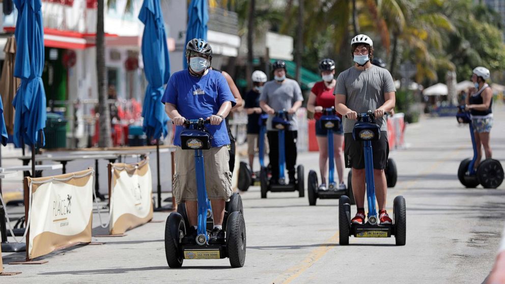 PHOTO: A tour group riding Segways rides down Miami Beach, Florida's famed Ocean Drive on South Beach, July 4, 2020.