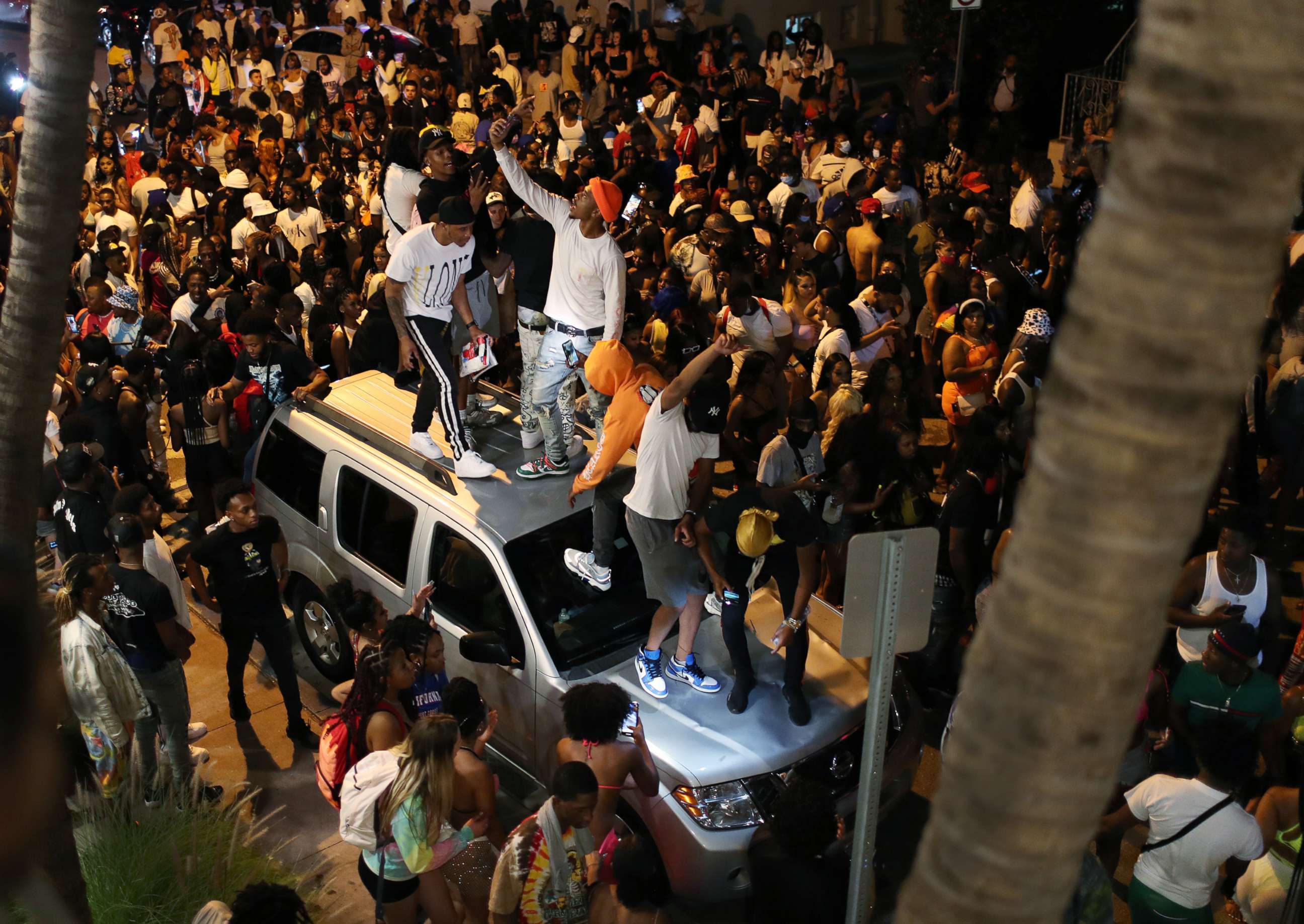 PHOTO: A crowd gathers while exiting the area as an 8pm curfew goes into effect, March 21, 2021, in Miami Beach, Fla.