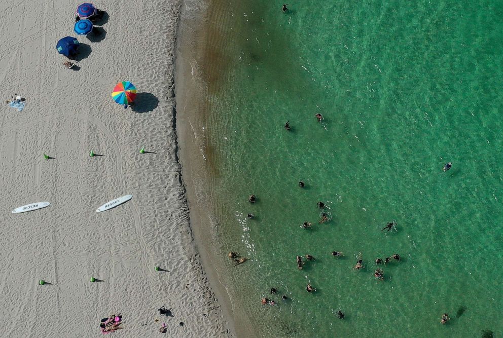 PHOTO: In an aerial view, people are seen on the beach at Haulover Park, July 11, 2023, in Miami.