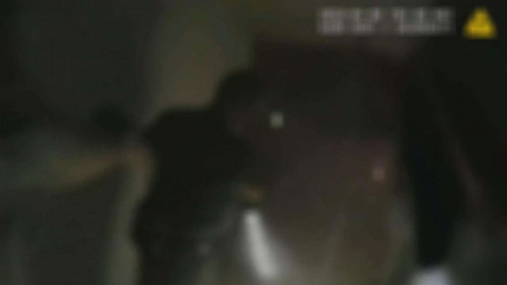 PHOTO: A still image made from police body cam video shows Miami Beach police officers helping a blind elderly woman from her home after it caught on fire, April 9, 2018.