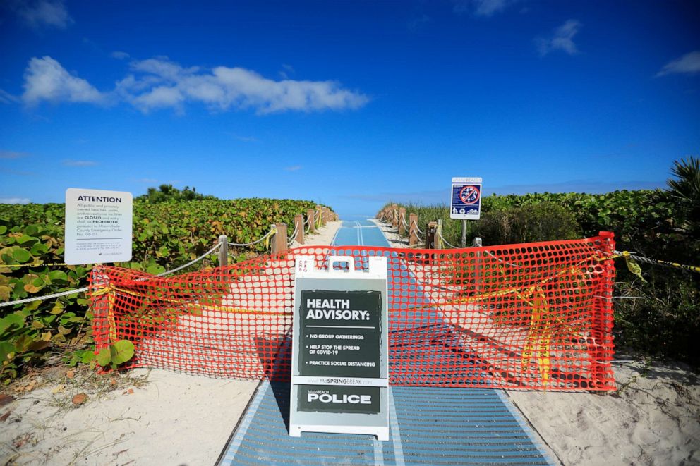 PHOTO: A beach entrance is closed off along the boardwalk in Miami Beach, Florida, on March 22, 2020.