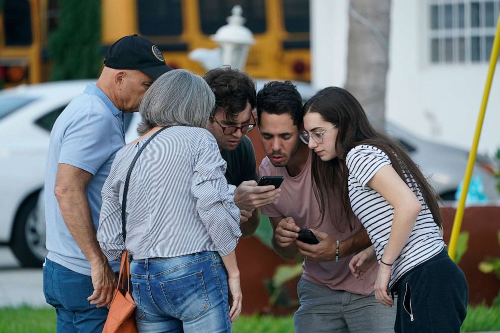 PHOTO: People wait for information after a partial building collapse, June 24, 2021, in Surfside, Fla.