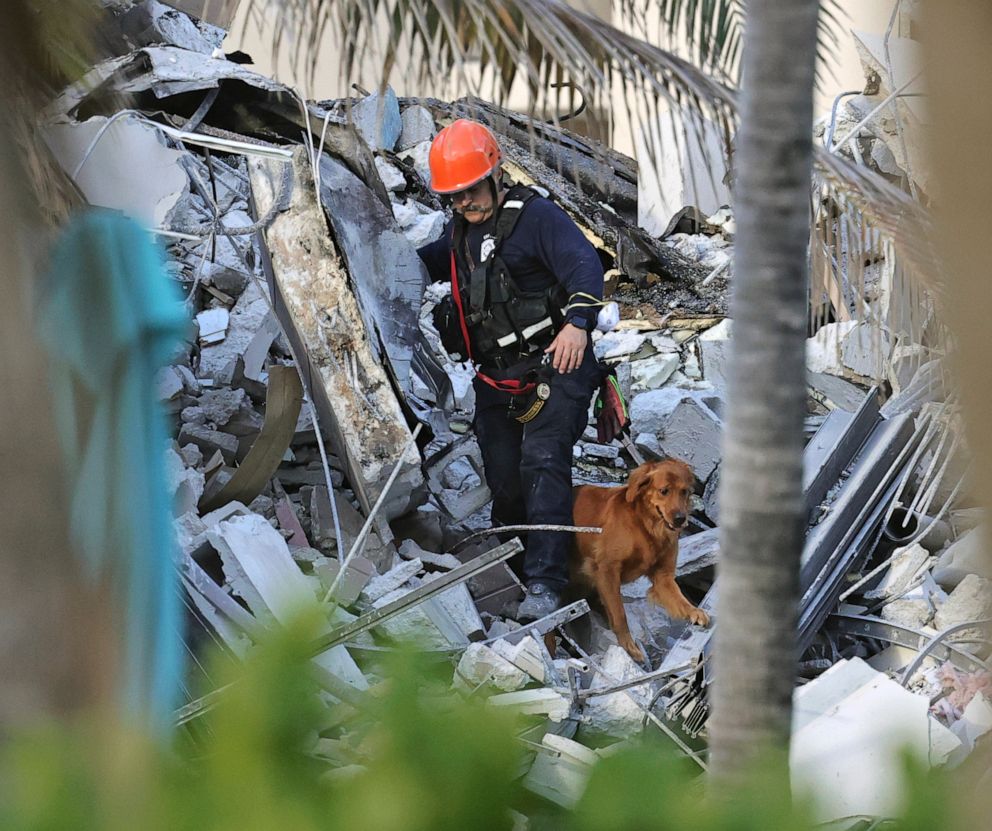PHOTO: Fire rescue personnel conduct a search and rescue with dogs through the rubble of the Champlain Towers South Condo after the multistory building partially collapsed in Surfside, Fla., Thursday, June 24, 2021.