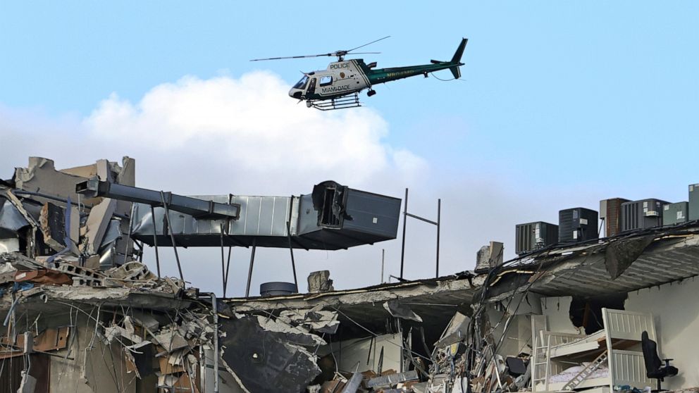 PHOTO: A Miami-Dade Police helicopter flies over the Champlain Towers South Condo after the multistory building partially collapsed, June 24, 2021, in Surfside, Fla.