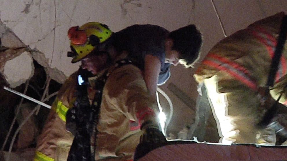 PHOTO: In an image made from video provided by ReliableNewsMedia, firefighters rescue a survivor from the rubble of the Champlain Towers South Condo after the multistory building partially collapsed in Surfside, Fla., early Thursday, June 24, 2021.