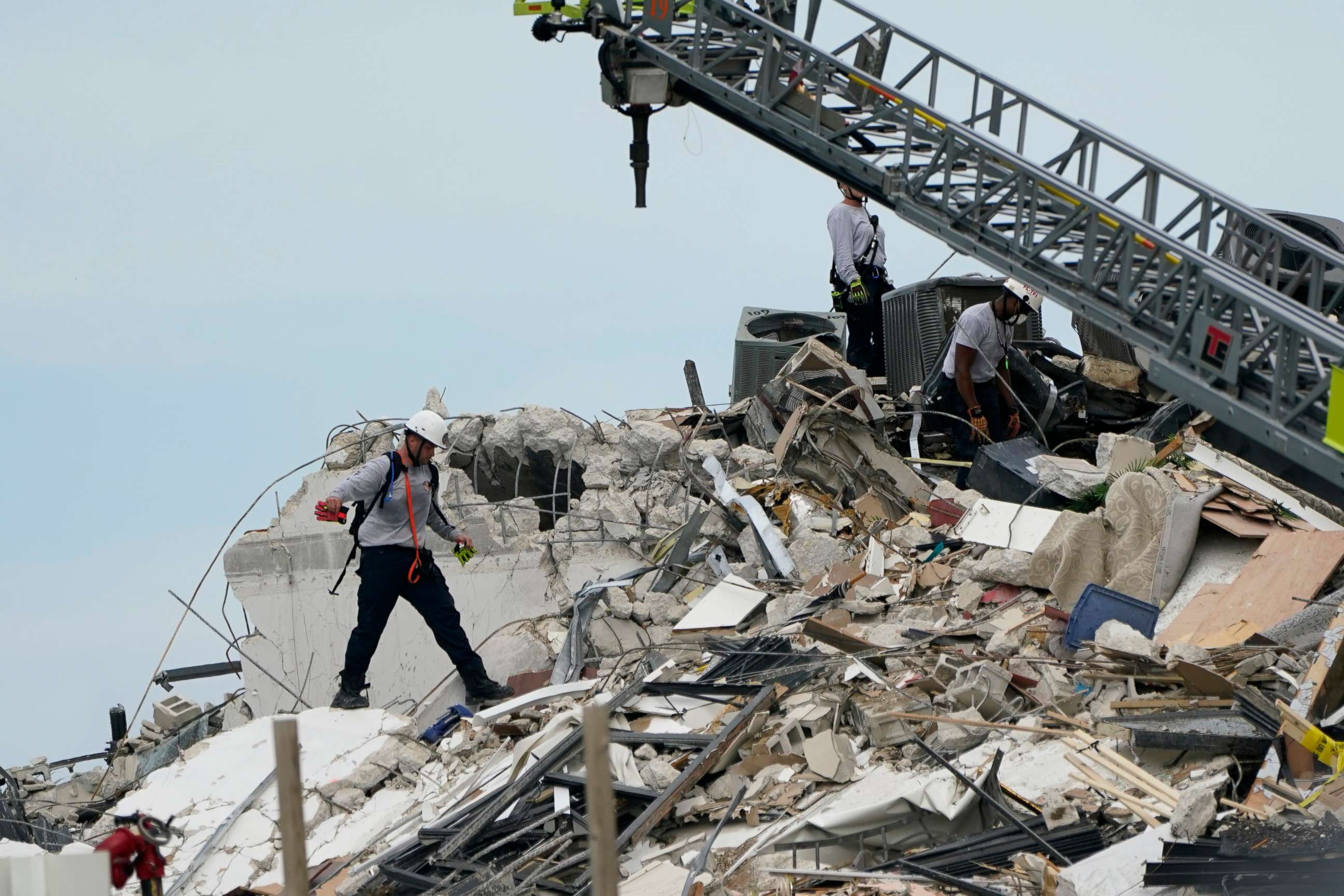 PHOTO: Rescue worker walk among the rubble where a wing of a 12-story beachfront condo building collapsed, June 24, 2021, Surfside, Fla.