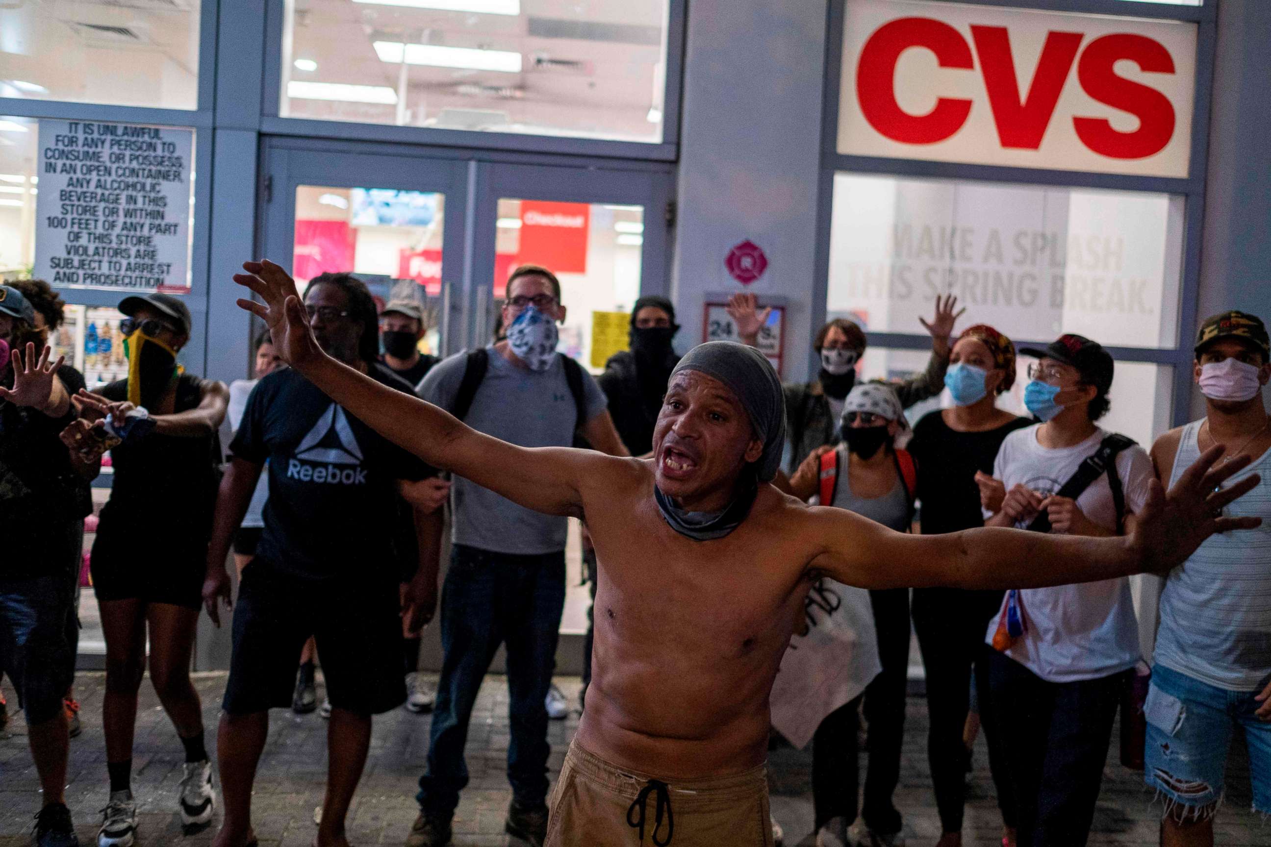 PHOTO: Protestors form a line in front of a CVS store to avoid people breaking the store windows during a rally in response to the recent death of George Floyd, an unarmed black man who died while in police custody in Minneapolis, in Miami, May 31, 2020.