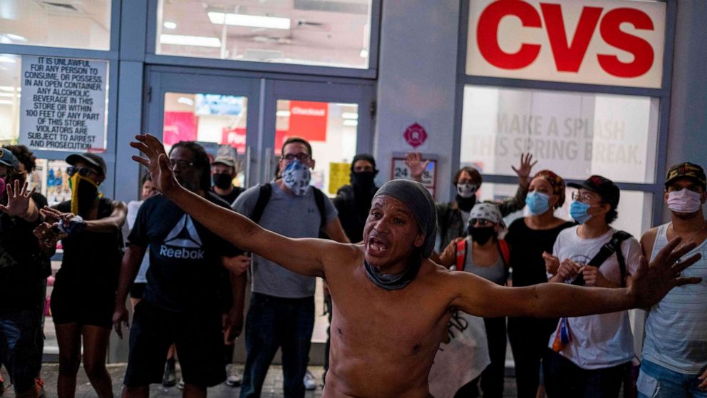 PHOTO: Protestors form a line in front of a CVS store to avoid people breaking the store windows during a rally in response to the recent death of George Floyd, an unarmed black man who died while in police custody in Minneapolis, in Miami, May 31, 2020.