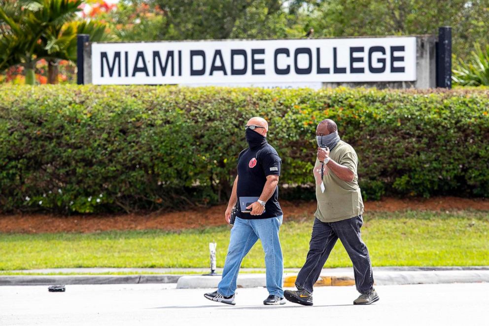 PHOTO: Detectives cross the street near the Miami-Dade Kendall Campus in Miami, Fla., June 6, 2021.
