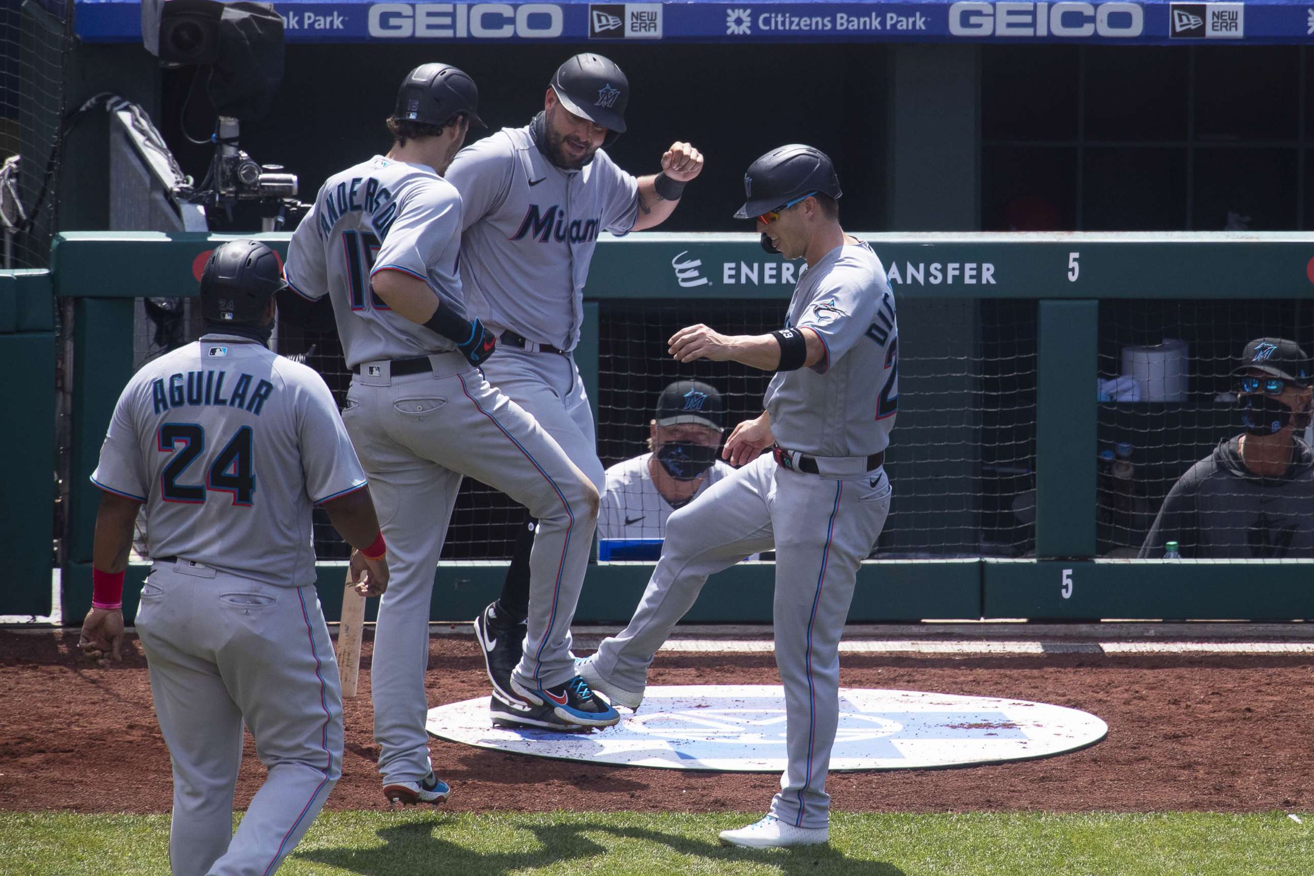 PHOTO: Jesus Aguilar #24, Brian Anderson #15, Francisco Cervelli #29, and Corey Dickerson #23 of the Miami Marlins react after a three run home run by Anderson against the Philadelphia Phillies at Citizens Bank Park on July 26, 2020, in Philadelphia.