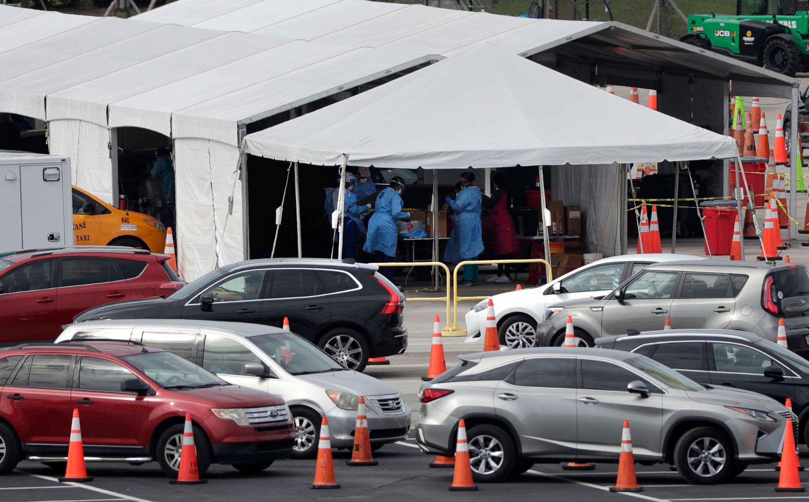 PHOTO: Lines of cars wait at a drive-through coronavirus testing site, July 5, 2020, outside in Miami Gardens, Fla. 