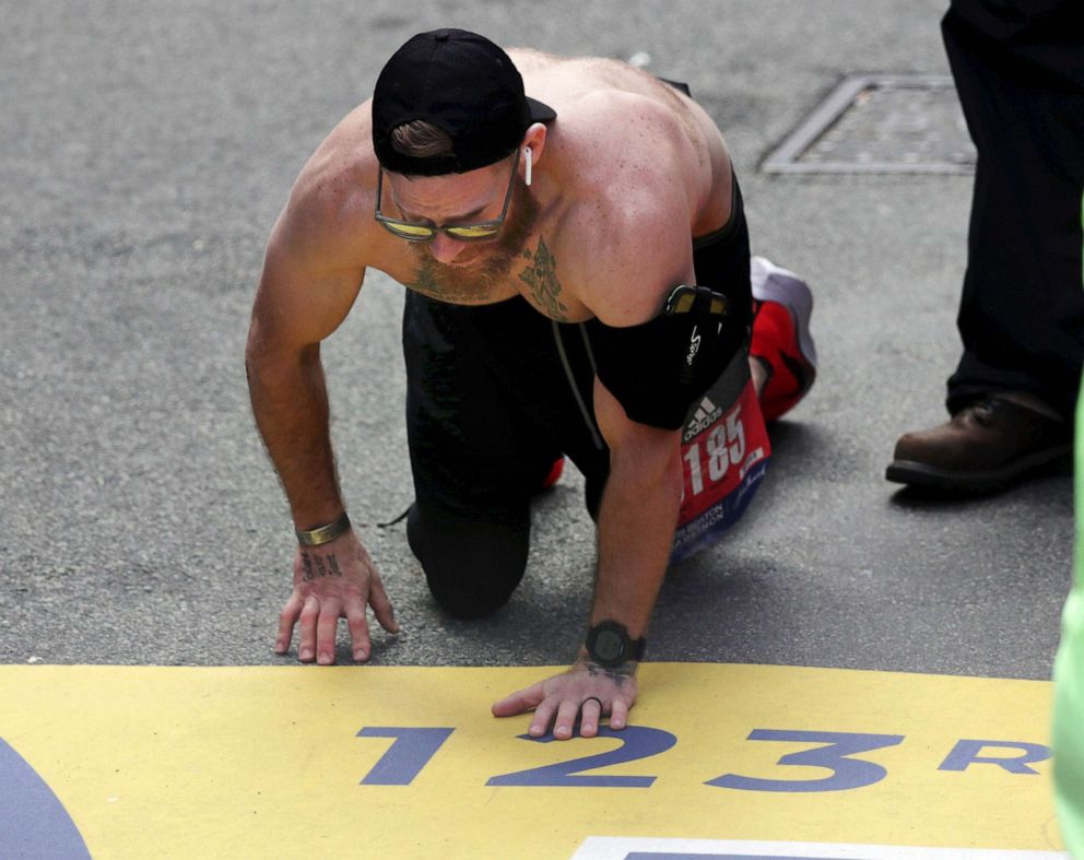 PHOTO: Micah Herndon, of Tallmadge, Ohio, crawls to the finish line in the 123rd Boston Marathon on April 15, 2019, in Boston.