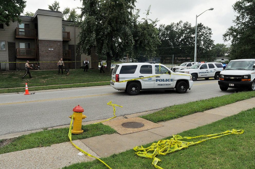 PHOTO: In this Aug. 9, 2014, file photo provided by the St. Louis County Prosecutor's Office, police officers investigate the scene of the shooting of Michael Brown on Canfield Drive in Ferguson, Missouri.