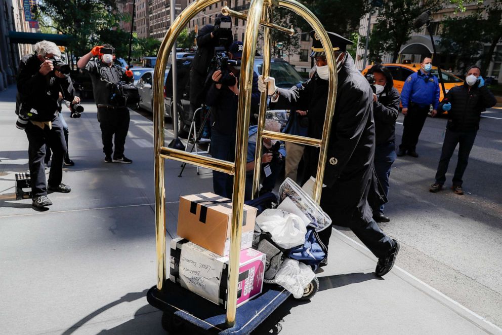 PHOTO: Personal belongings delivered from the vehicle Michael Cohen arrived in are brought into his Manhattan apartment building, May 21, 2020, in New York.