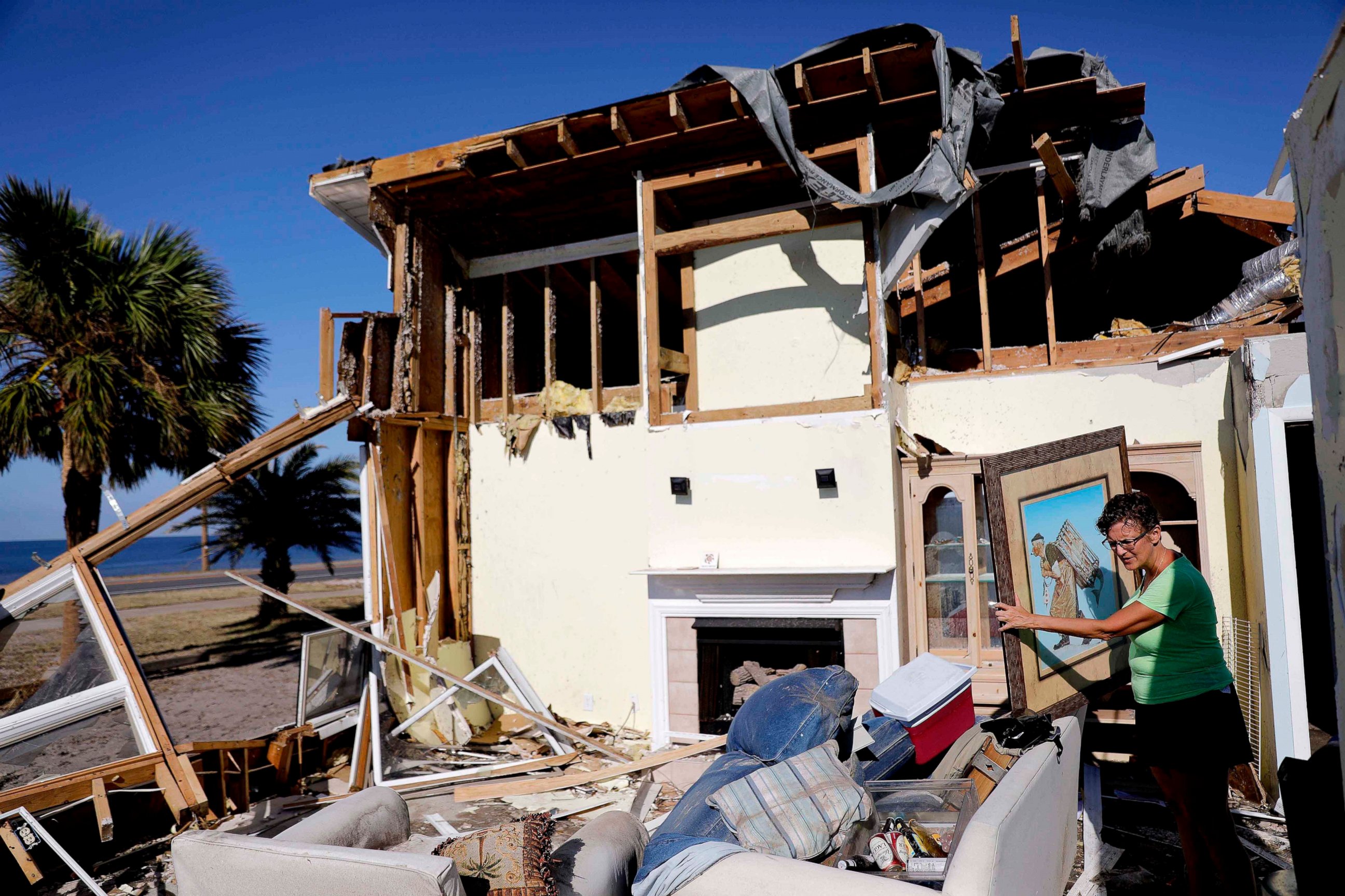 PHOTO: Lavonia Fortner helps her father-in-law, John E. Fortner, search for memorabilia his wife collected, in the aftermath of Hurricane Michael in Mexico Beach, Fla., Saturday, Oct. 13, 2018. 