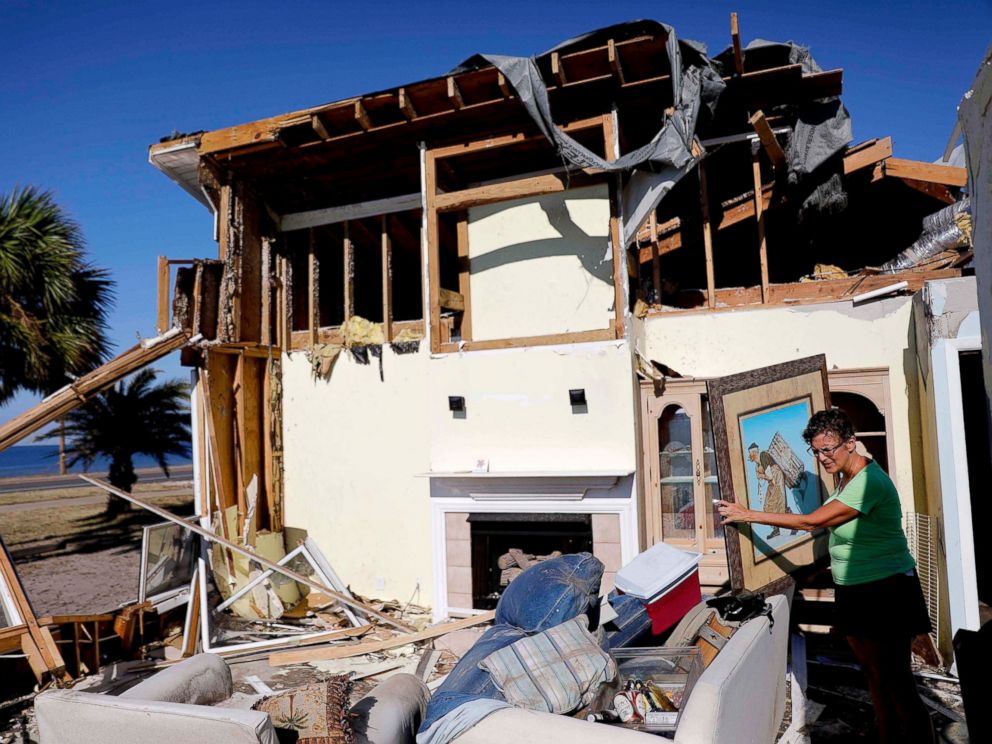 PHOTO: Lavonia Fortner helps her father-in-law, John E. Fortner, search for memorabilia his wife collected, in the aftermath of Hurricane Michael in Mexico Beach, Fla., Saturday, Oct. 13, 2018. 