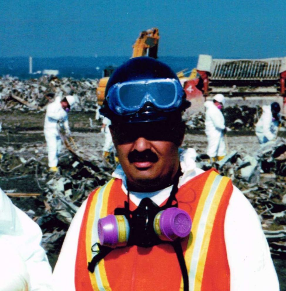 PHOTO: NYPD Sergeant Michael Guedes is pictured at the Fresh Kills landfill in Staten Island, New York, while workers sort through debris from the 9/11 attack in the background.